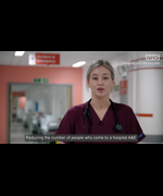 A still from the video. A nurse in her uniform. Text reads "reducing the number of people who come to a hospital A&E"
