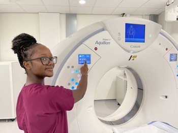 Radiographer Annie Murambiwa with a new CT scanner at Wirral Diagnostics Centre
